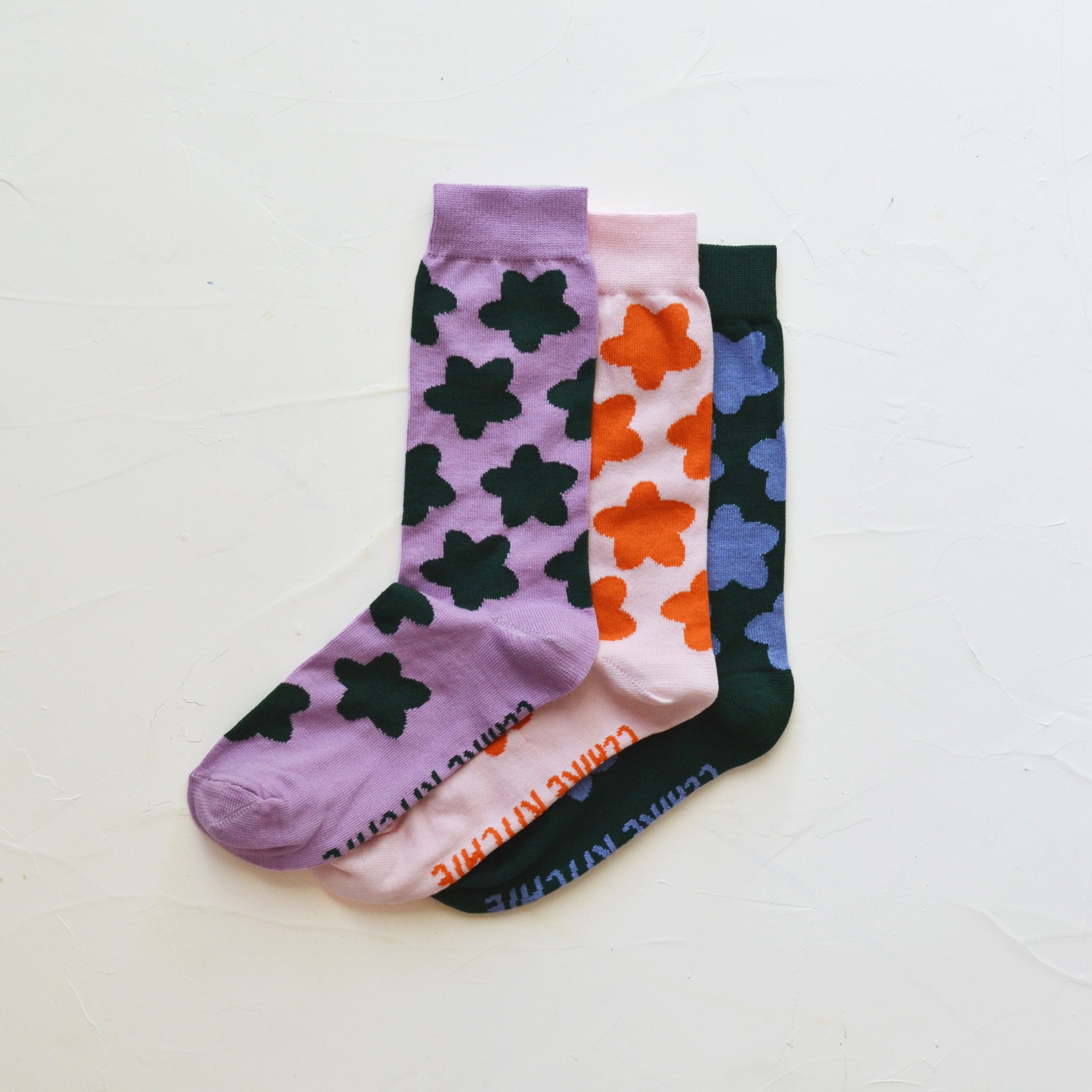 a trio of flower socks laying together neatly