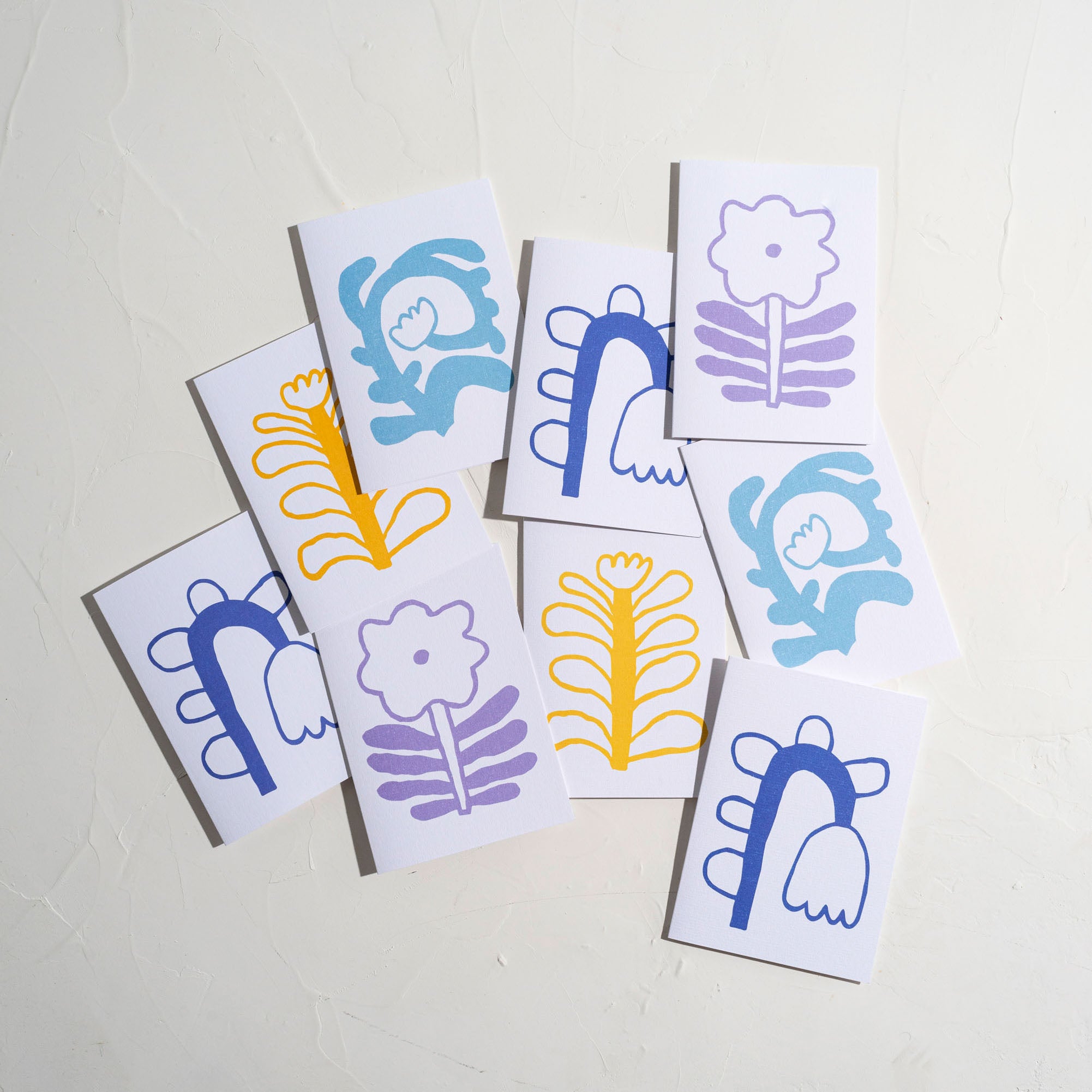 A cluster of gift cards with organic and colourful flower shapes.