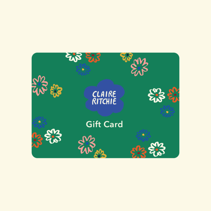 This image shows a green Claire Ritchie gift card with the logo in the center, surrounded by smaller flowers and the words 'Gift Card' below the center. 